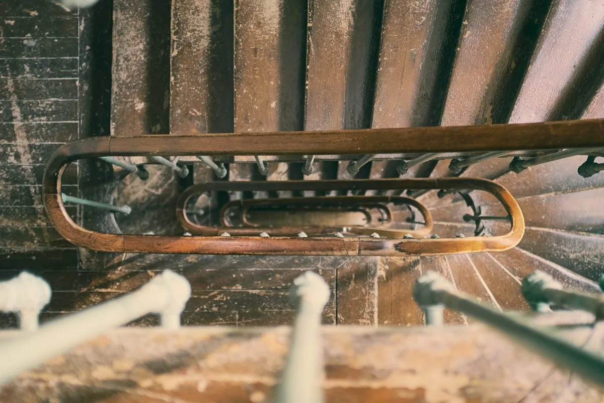 a wooden staircase with metal bars