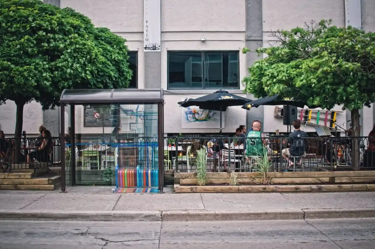 people sitting at a table outside a building